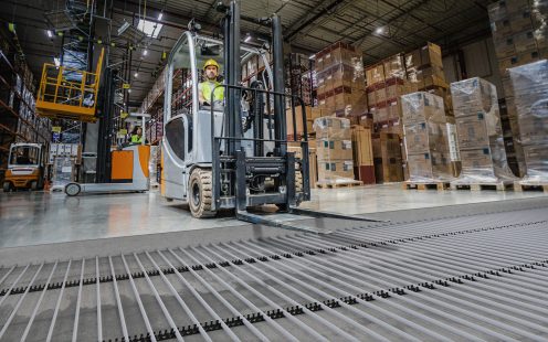 Forklift operator during work in large warehouse