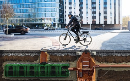 Male courier with bicycle delivering packages in city. Copy space.